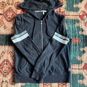 Victoria's Secret Women's Black Zip-Up Sweatshirt with Striped Sleeves.